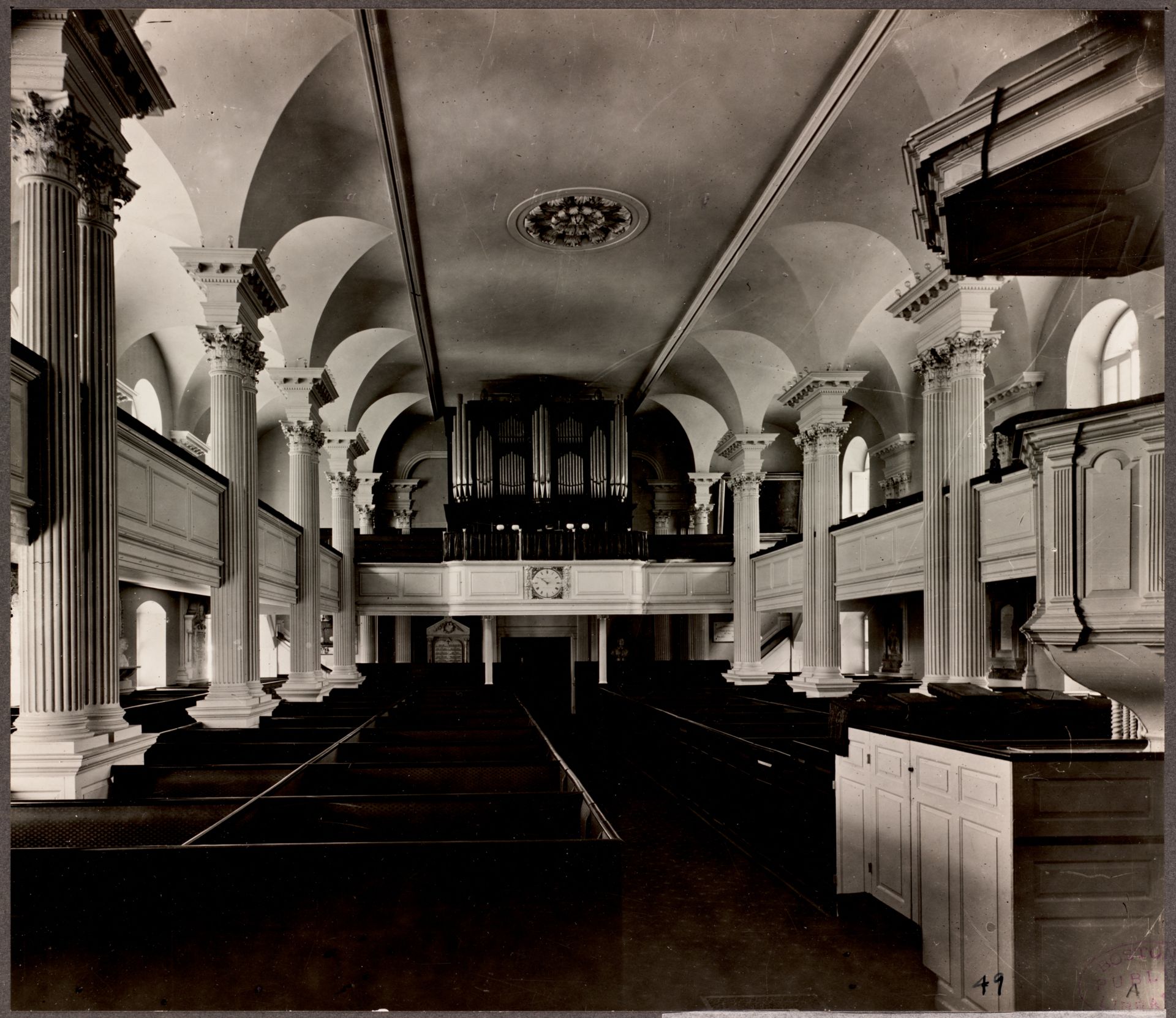 Inside of Chapel, showing first floor and balcony pews, with pipe organ in the far back. 