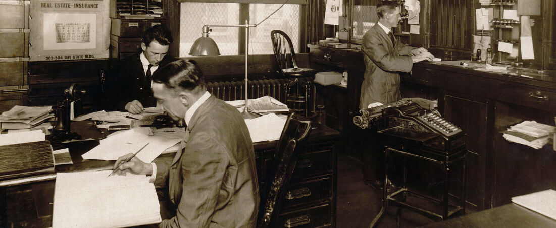 Three men working behind the windows at the Lawrence, Massachusetts Post Office