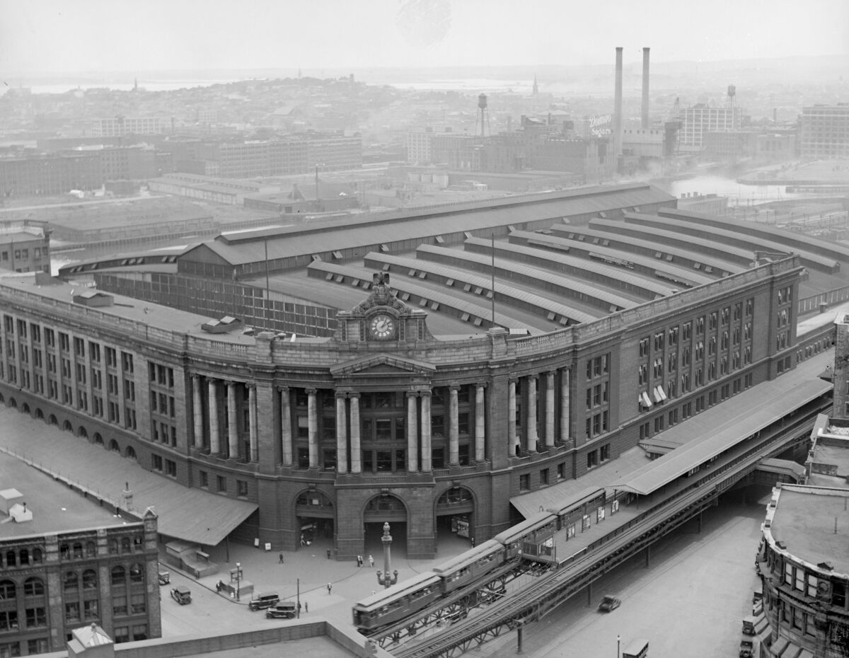 A historic black and white photograph shows South Station