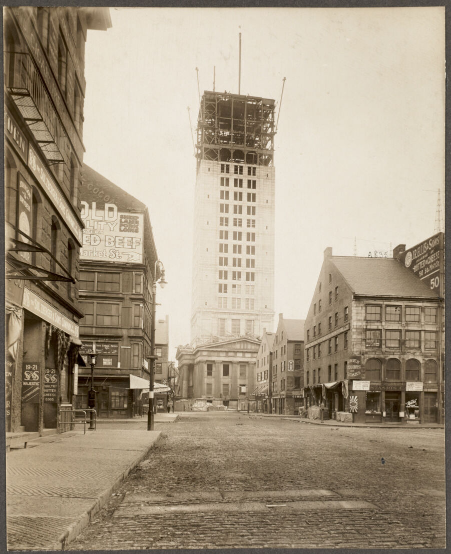 This photograph (ca. 1913-1915) shows the streets of Boston as the now iconic Custom House Tower is constructed.