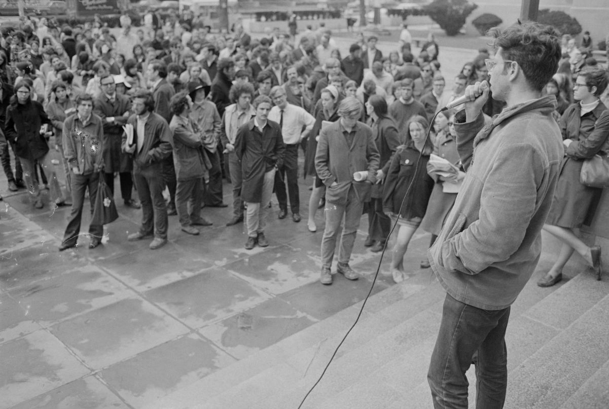 Student addressing crowd during rally in support of SDS members at Harvard, 1969.