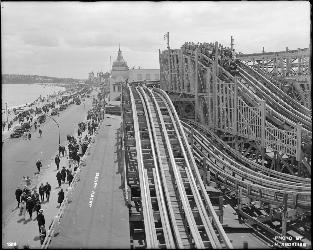 This photograph from 1920 depicts a bustling Revere Beach, with the Derby Racer roller coaster in the midst of delighting its users.